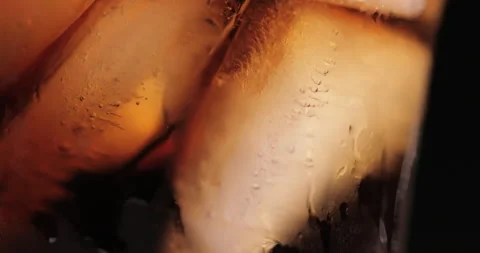 Ice cubes in a glass with cola Stock Footage 133596184