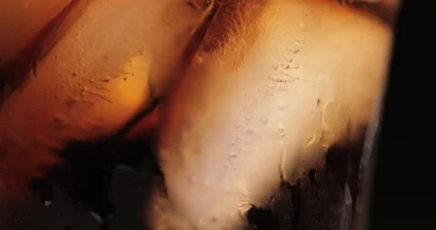 Ice cubes in a glass with cola Stock Footage 133596526