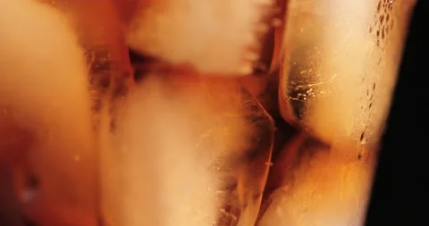 Ice cubes in a glass with cola Stock Footage 133597086