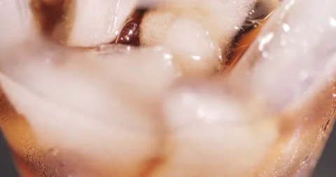 Ice cubes in a glass with cola Stock Footage 133599827