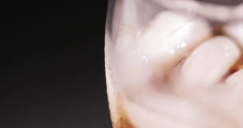 Ice cubes in a glass with cola Stock Footage 133601913