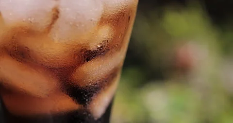 Ice cubes in a glass with cola Stock Footage 133602517
