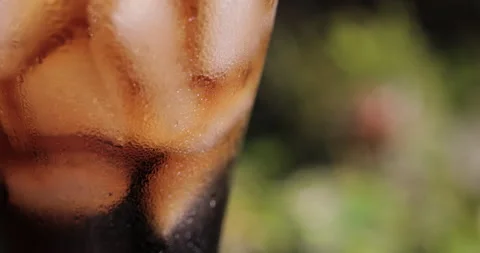 Ice cubes in a glass with cola Stock Footage 133602814