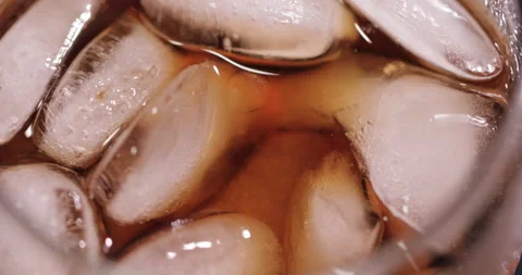 Ice cubes in a glass with cola Stock Footage 133603961