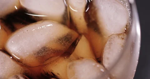 Ice cubes in a glass with cola Stock Footage 133604236
