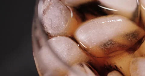 Ice cubes in a glass with cola Stock Footage 133604753