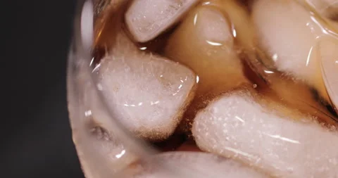 Ice cubes in a glass with cola Stock Footage 133605410