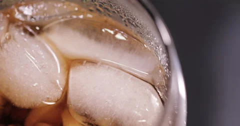 Ice cubes in a glass with cola Stock Footage 133606134