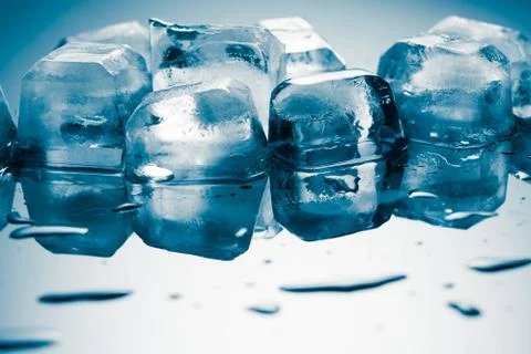 Ice cubes on glossy table Stock Photos