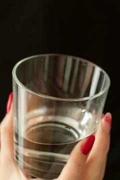 Ice cubes in the hand. Black background. A glass of water. Cold. Frozen. Whit Stock Photos
