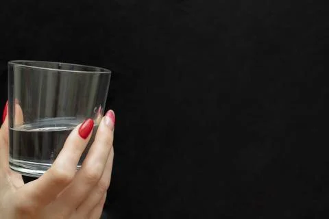 Ice cubes in the hand. Black background. A glass of water. Cold. Frozen. Whit Stock Photos