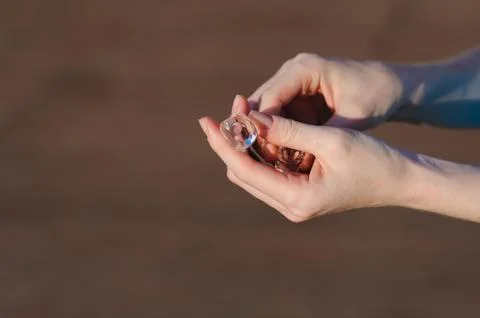 Ice cubes in human hands Stock Photos