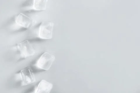 Ice cubes on light background, top view. Space for text Stock Photos