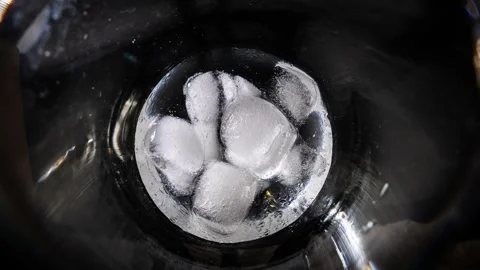 Ice Cubes Melting Rapidly Inside Clear Glass Tumbler in Time Lapse Stockbeeldmateriaal 339366202