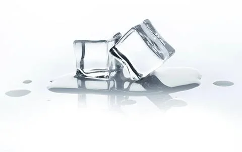 Ice cubes melting on a white surface with water drops Stock Photos