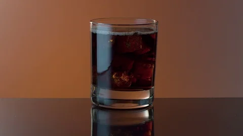 Ice cubes moving in a fizzy drink Stock Footage 124900239