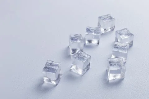 Ice cubes pattern on bright background. Flat lay summer drink minimal concept 写真素材