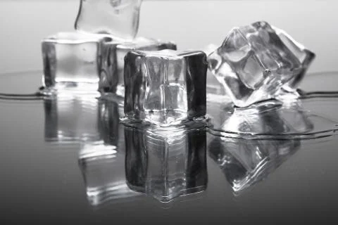 Ice cubes on a reflective surface Stock Photos