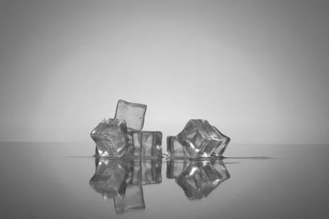 Ice cubes on a reflective surface Stock Photos