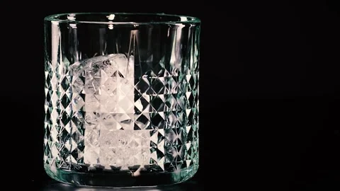 Ice Cubes Settling in Patterned Glass Stock Footage 326080974
