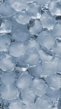 Ice cubes on a silver backdrop. Cold winter texture background. Stock Photos