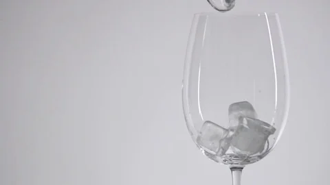 Ice cubes slide in a glass. Stock Footage 77610469