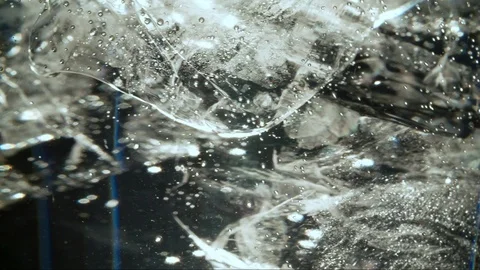 Ice cubes in soda water bubbles slow motion macro Stock Footage 124794365