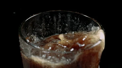 Ice Cubes Splashing into Cold Cola Soda with Fizzy Foam Stock Footage 346087335