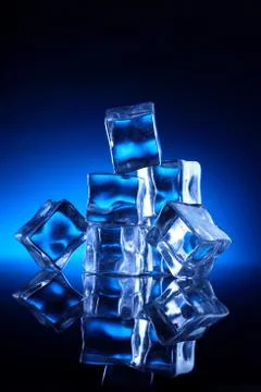 Ice Cubes Stacked up on Blue Background Stock Photos