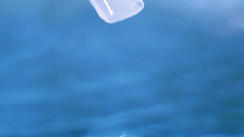 Ice cubes into still water Stock Footage 87294348