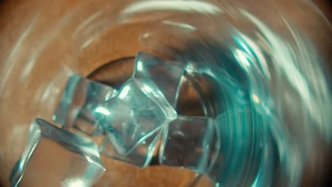 Ice Cubes Swirling Inside a Clear Glass to Create a Refreshing Drink Concept 库存影片 331099004