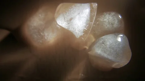 Ice cubes on a wet surface. 4K UHD Stock Footage 73340700