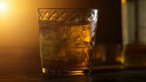 Ice cubes in a whiskey Stock Footage 107997922