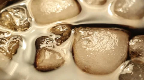 Ice cubes in a white liquid Stock Footage 60563564