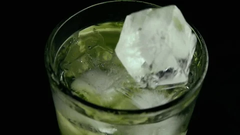 Ice in the cucumber water with ice drops. Slow motion Stock Footage 75715952