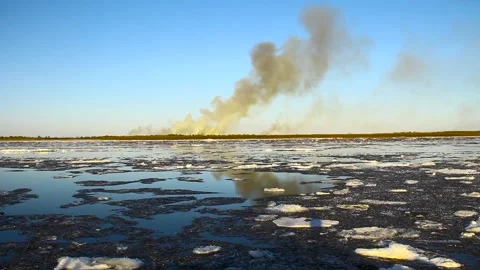 Ice drift on the big river and forest fire Stock Footage 100452757