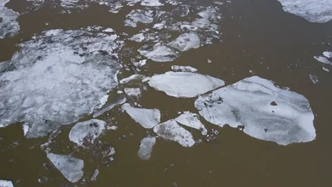 Ice Drift Occurs on a River next to a Port with Big Cranes Stock Footage 194344421