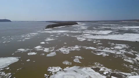 Ice Drift Occurs on River next to a Island with Forest, Aerial view Stock Footage 194344814