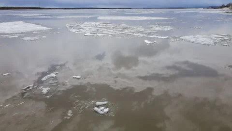 Ice Drift Occurs on the River next to the Mountains Ridge cover Forest in Spring Stock Footage 194345463