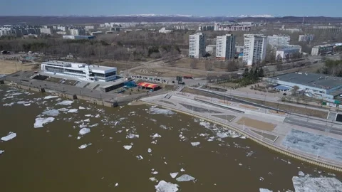 Ice Drift Occurs on a River next to the River Station in Country City, Mountain Stock Footage 194345567
