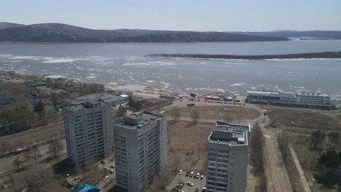 Ice Drift Occurs on the River next to High Buildings in City Stock Footage 194345661