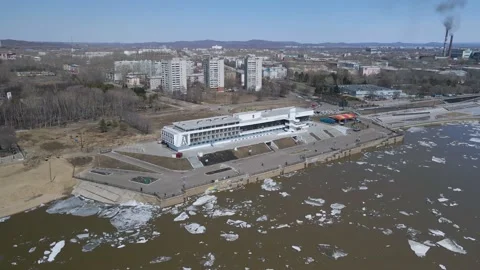 Ice Drift Occurs on a River next to a River Station in Country City, Mountains Stock Footage 194345745