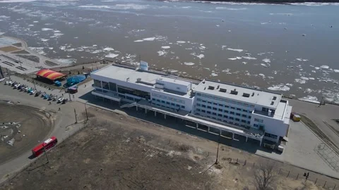 Ice Drift Occurs on the River next to a River Station in Country City, Mountain Stock Footage 194345761