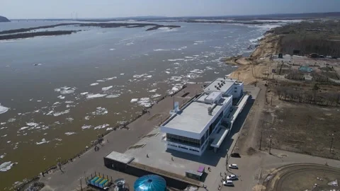 Ice Drift Occurs on the River next to the River Station in a City, Mountains Stock Footage 194347616