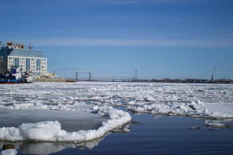 Ice drift on the river in the spring in the northern city Stock Photos