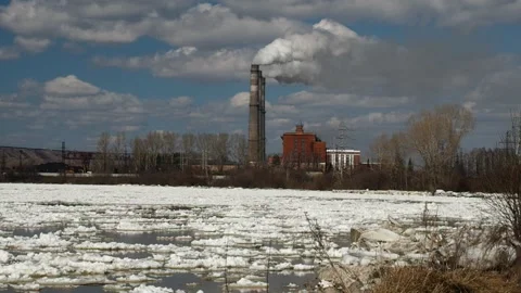 Ice drift in the spring. Coal power plant emitting carbon dioxide pollution. Stock Footage 88537726