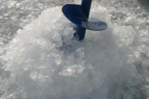 Ice drill in the hole Stock Photos
