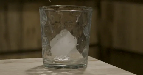 Ice Drop Into Glass 2 Stock Footage 138076871