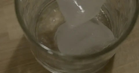 Ice Drop Into Glass Close Stock Footage 138077389