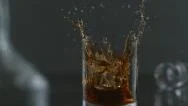 Ice Is Dropped Into Glass Of Whisky In Slow Motion; Shot On Phantom Flex 4K  Stock Footage